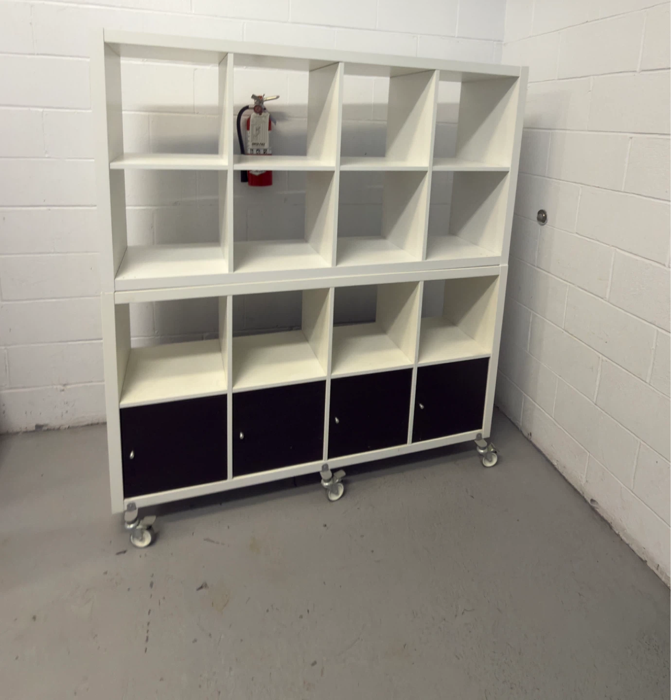 White 12-Cube Storage Shelf with Black Doors on Wheels
