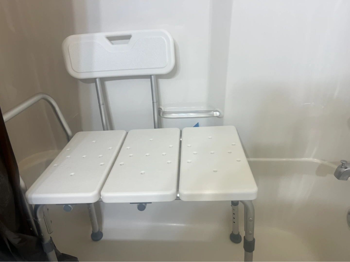 White adjustable shower chair with backrest