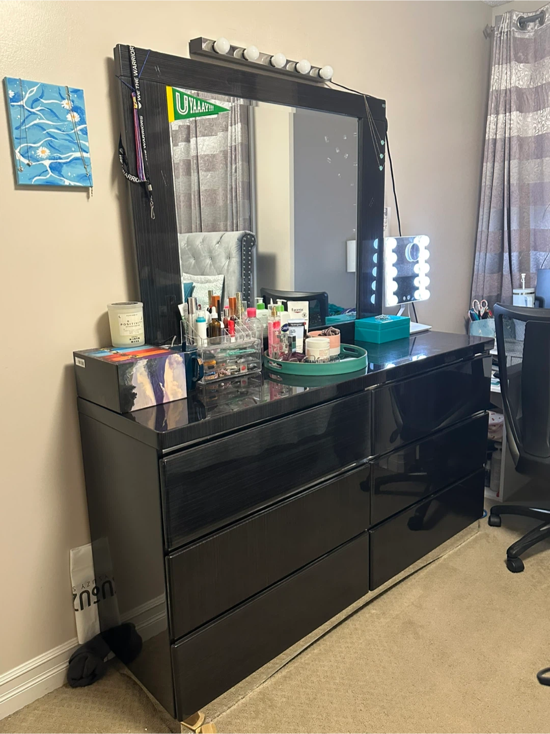 Black dresser with mirror and lights