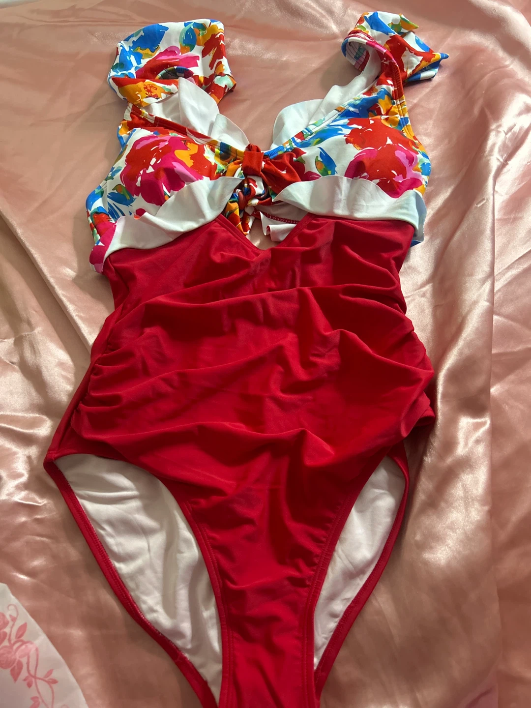 Red one-piece swimsuit with floral ruffle trim