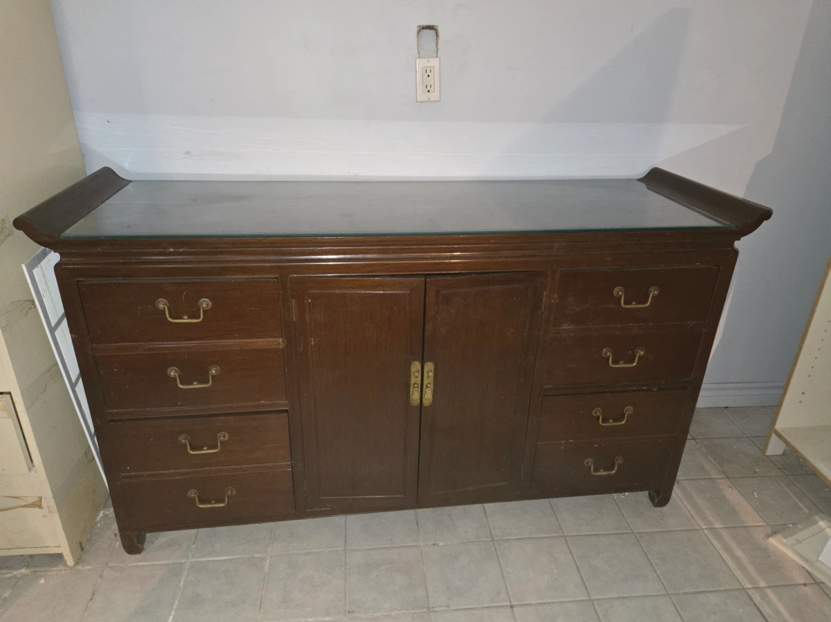 Brown wooden sideboard with glass top