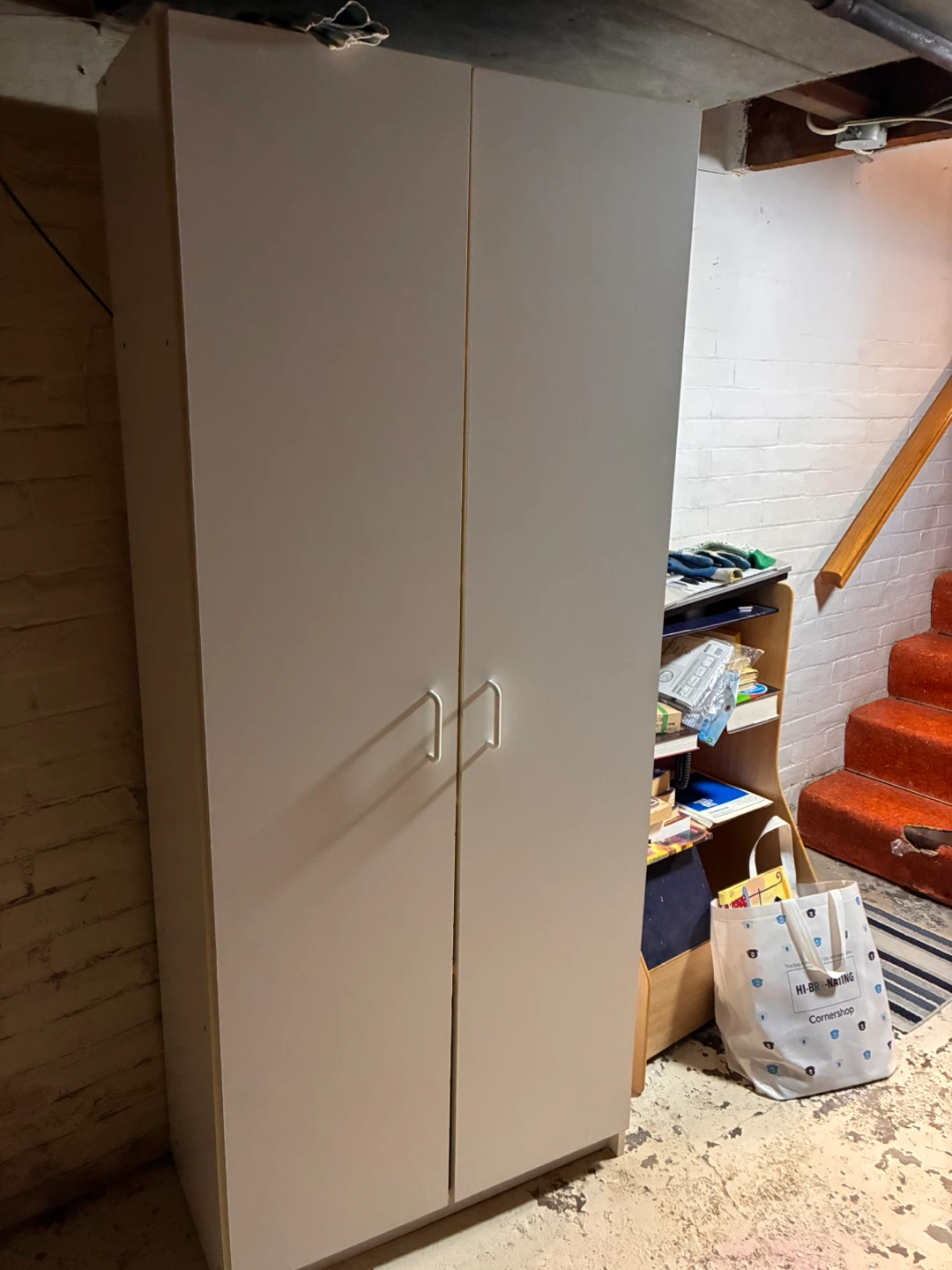 Tall white shelf with doors