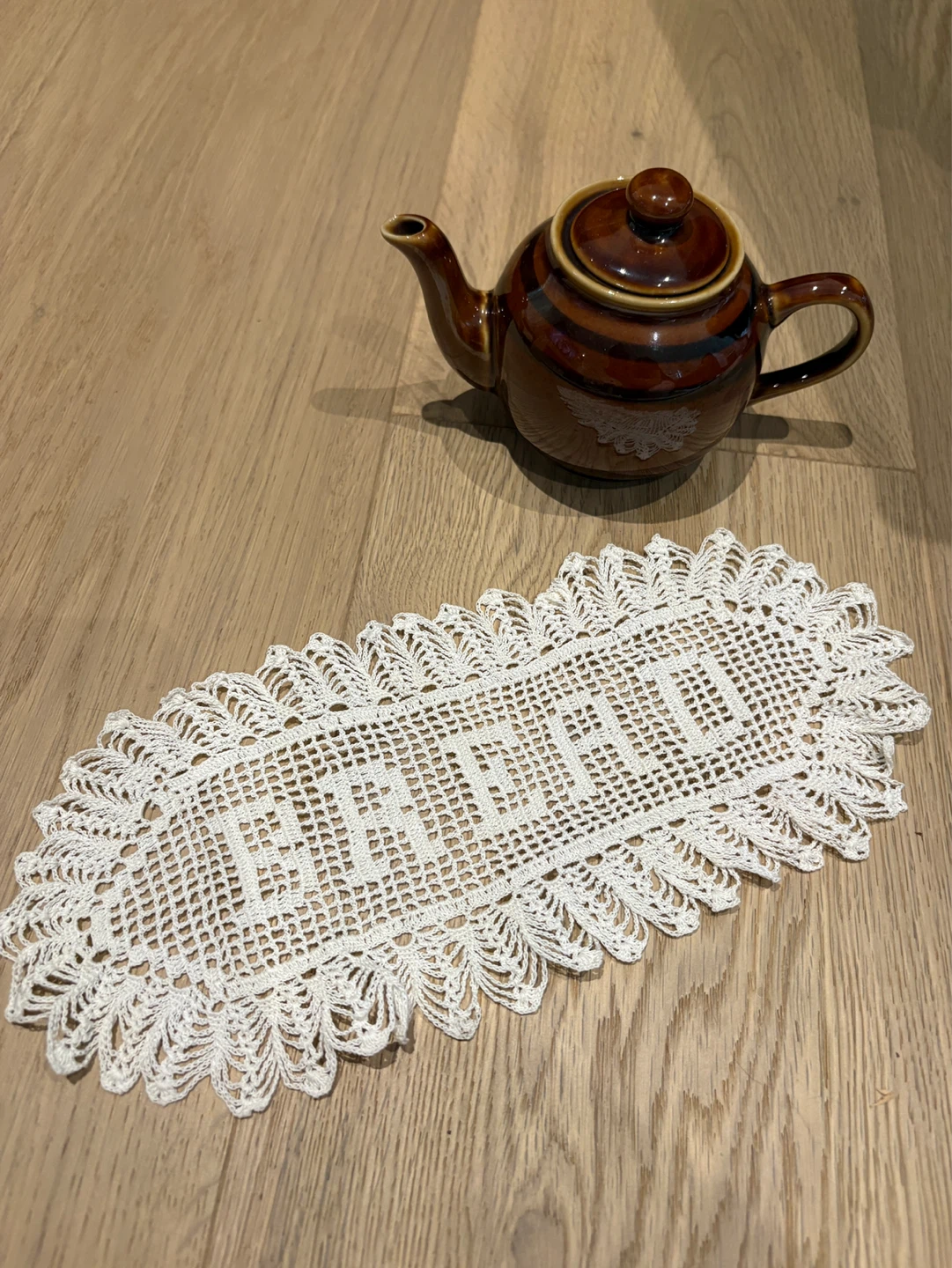 White Crochet Doily and Small Teapot