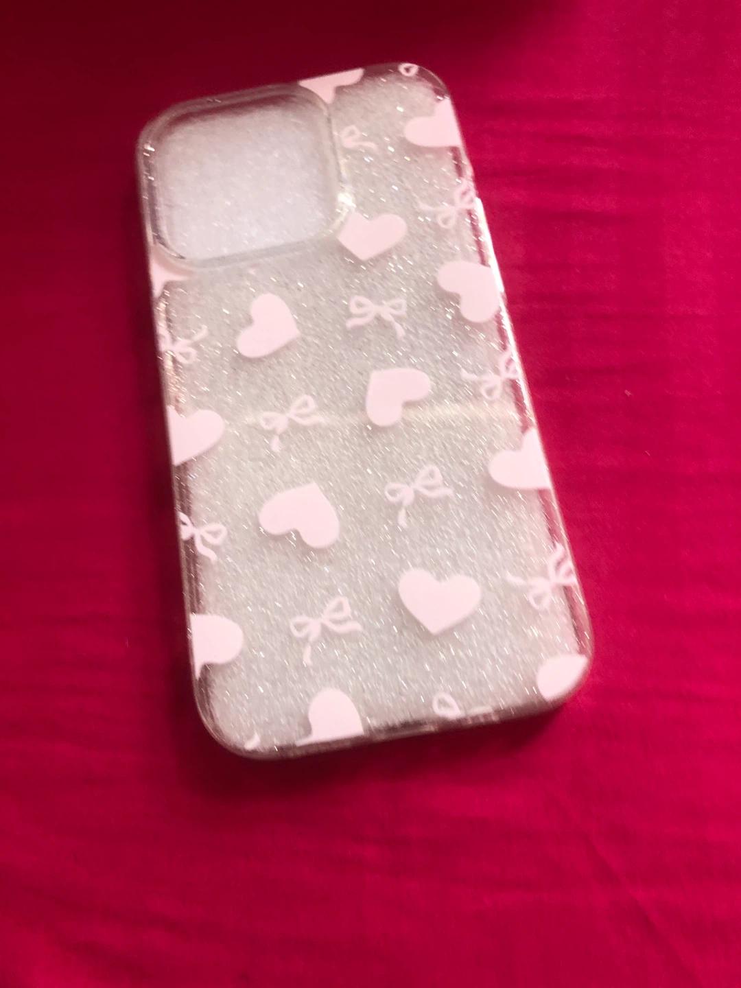 Clear phone case with pink hearts and bows