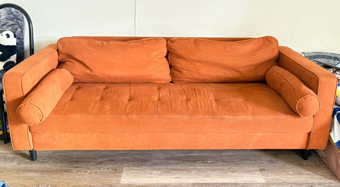 Orange Sofa with Bolster Pillows
