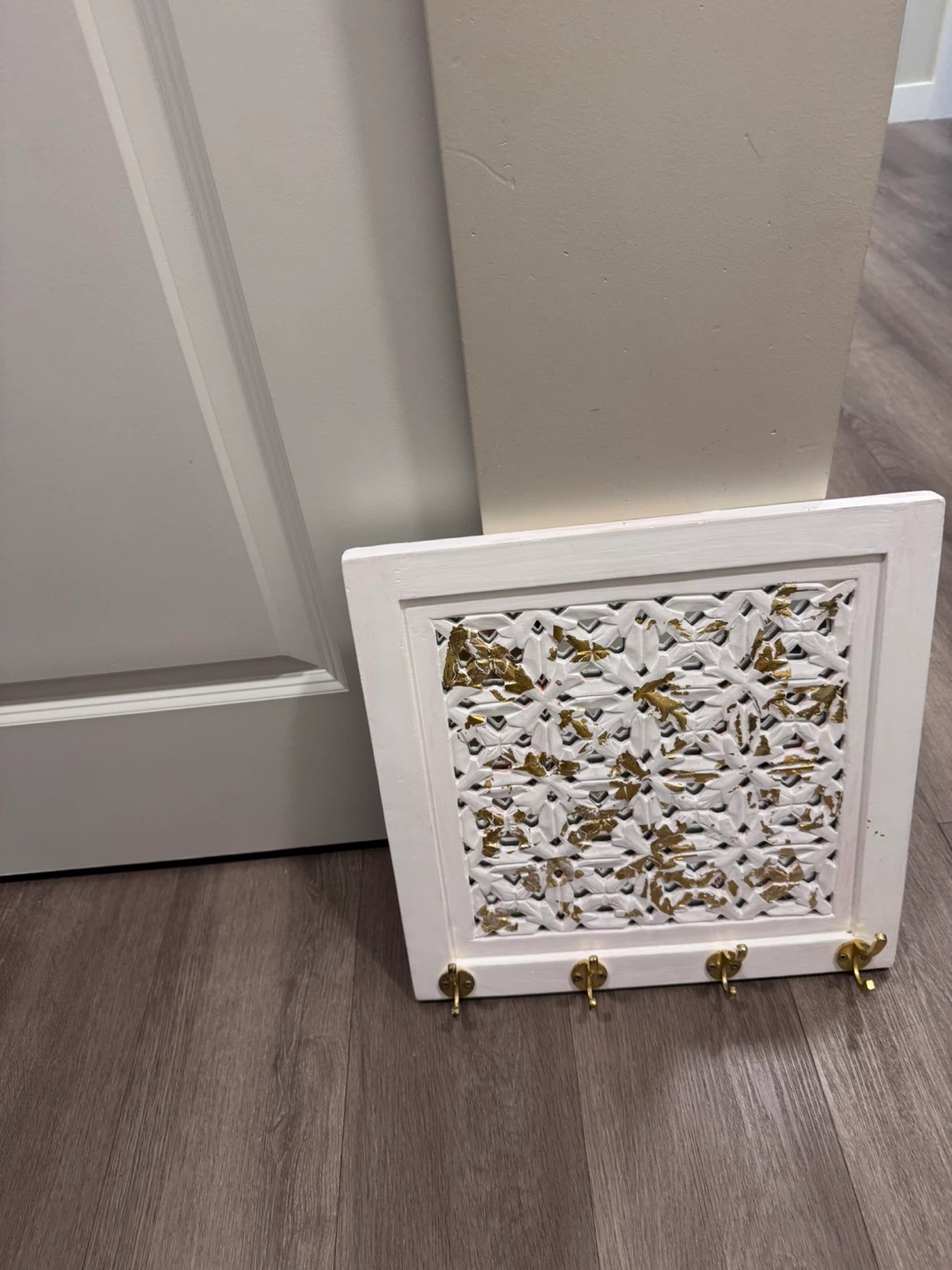 White decorative key holder with gold accents