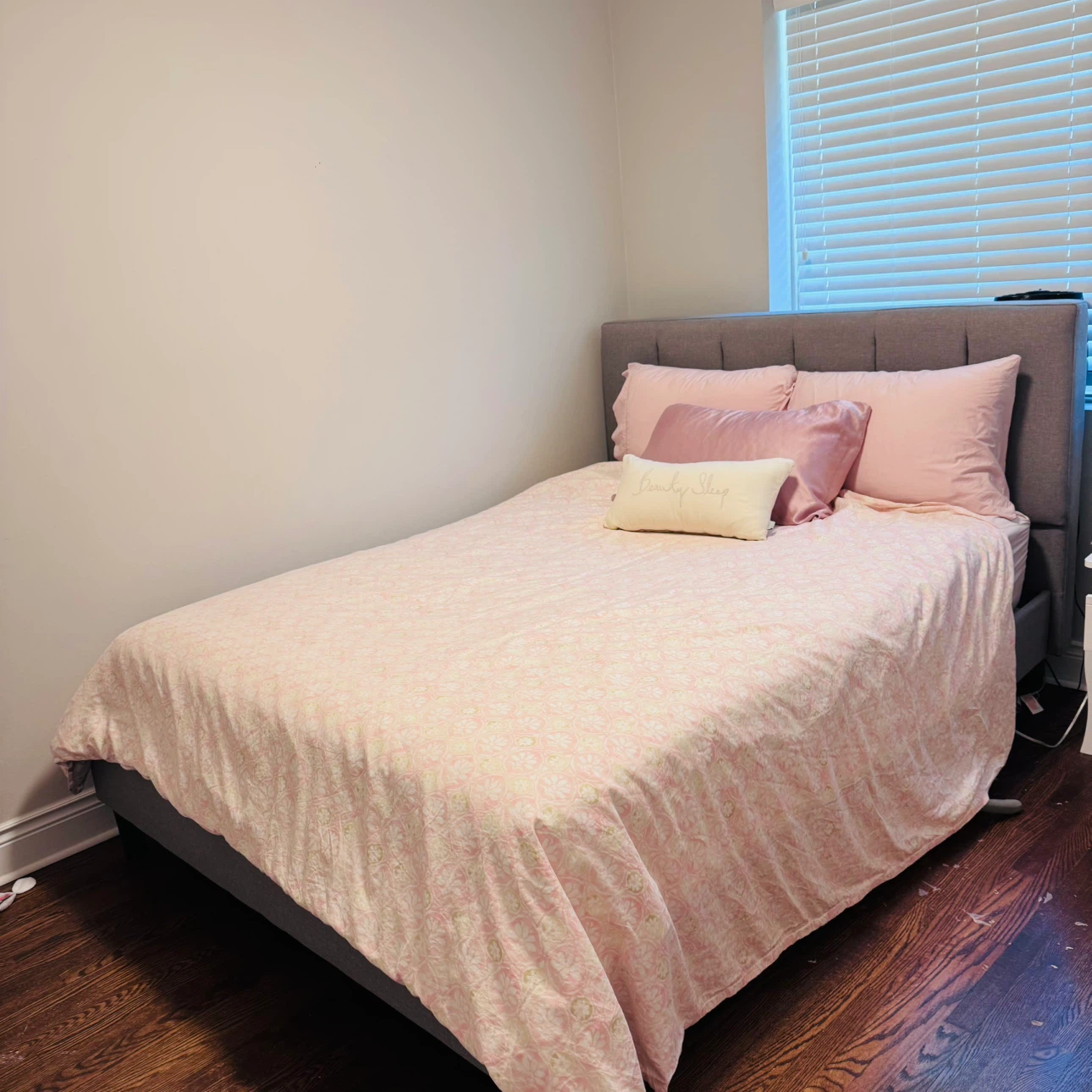 Gray Upholstered Queen Bed Frame with Pink Bedding