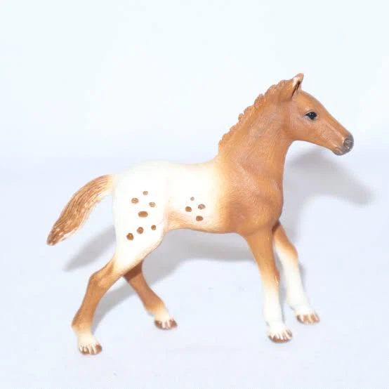 Brown and white spotted horse figurine