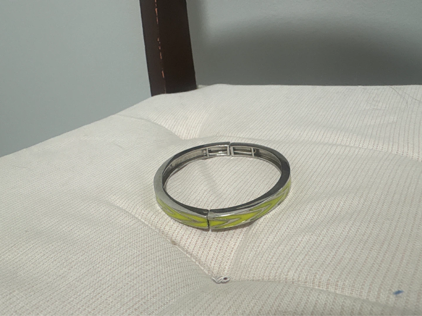 Silver tone and yellow patterned hinged bangle bracelet
