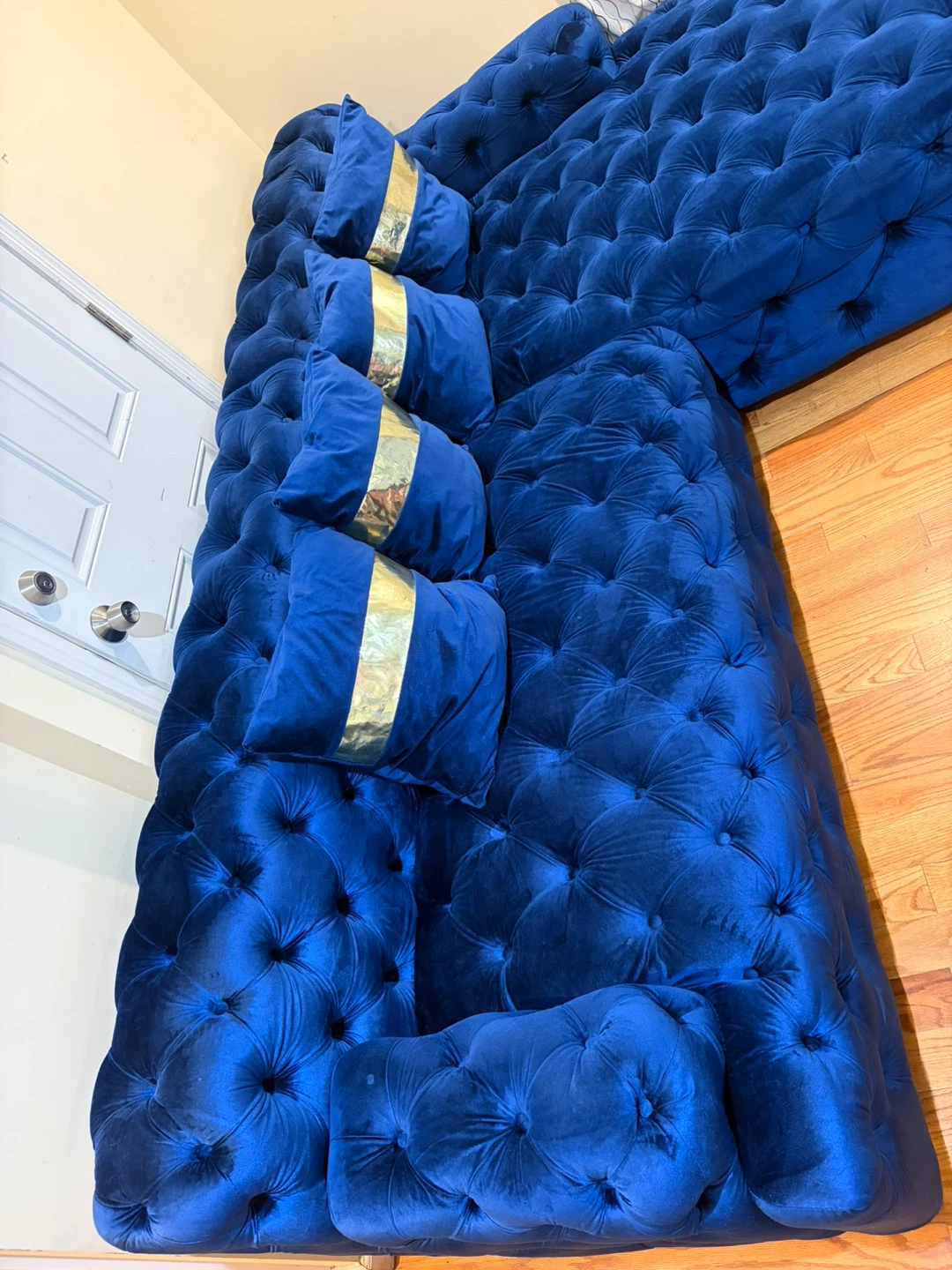 Blue Tufted Velvet Sectional Sofa with Gold Accent Pillows