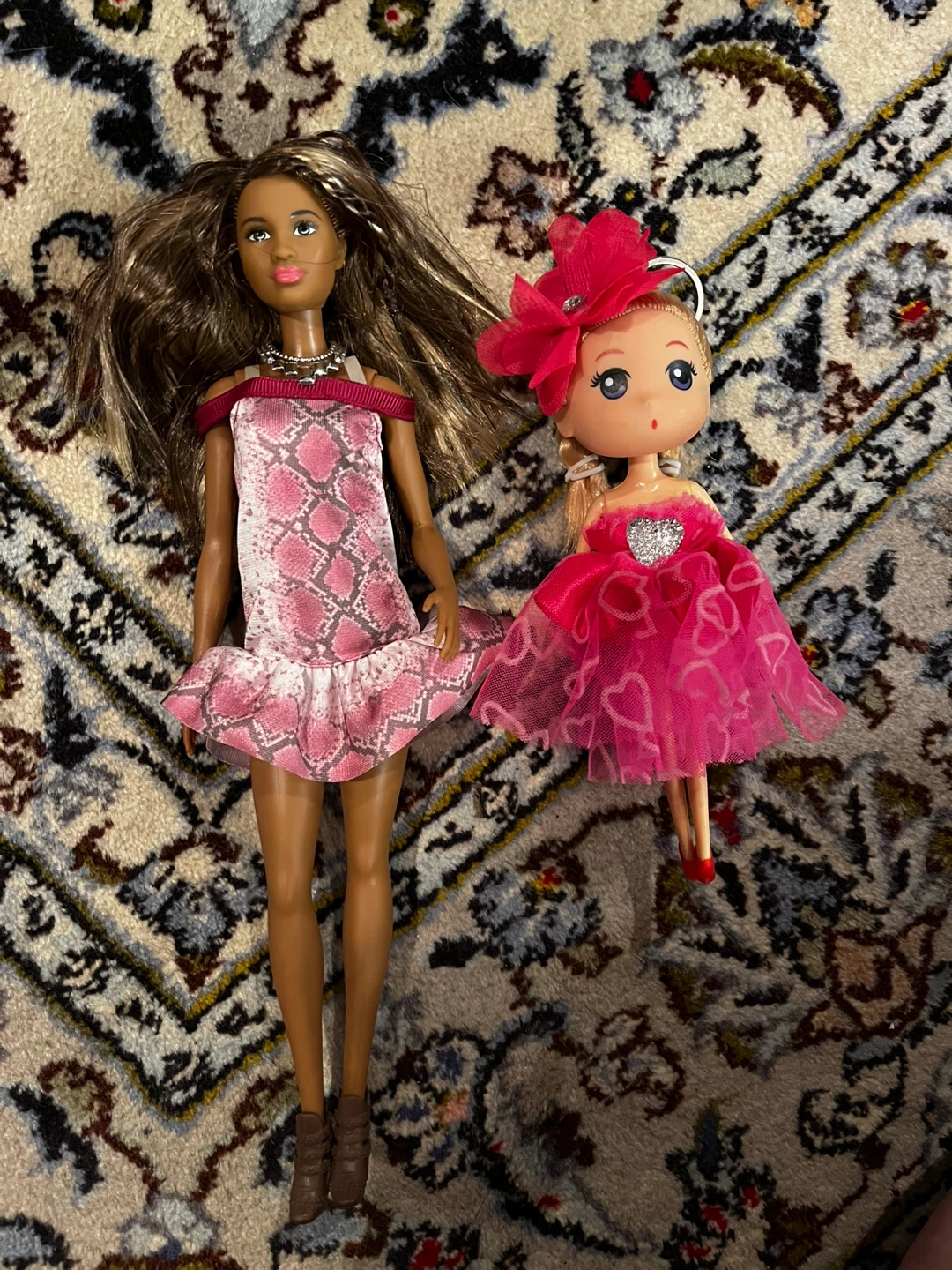 Two fashion dolls with pink outfits