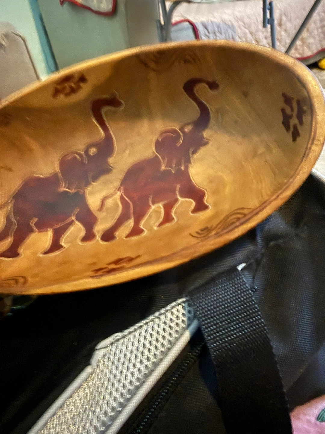 Hand-carved wooden decorative bowl with elephants