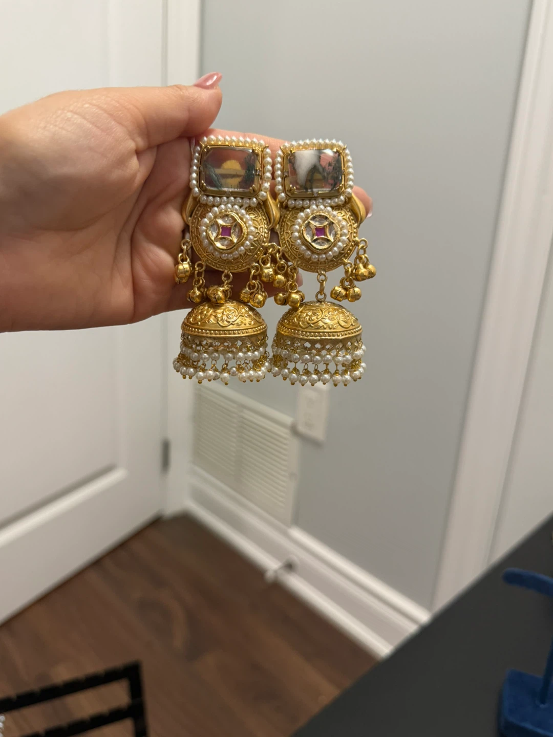 Gold tone Jhumka earrings with red stone