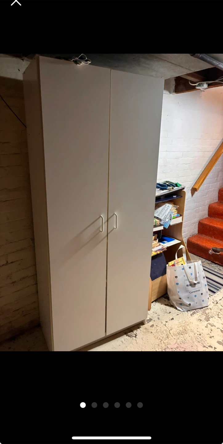 Tall white shelf with 2 doors.