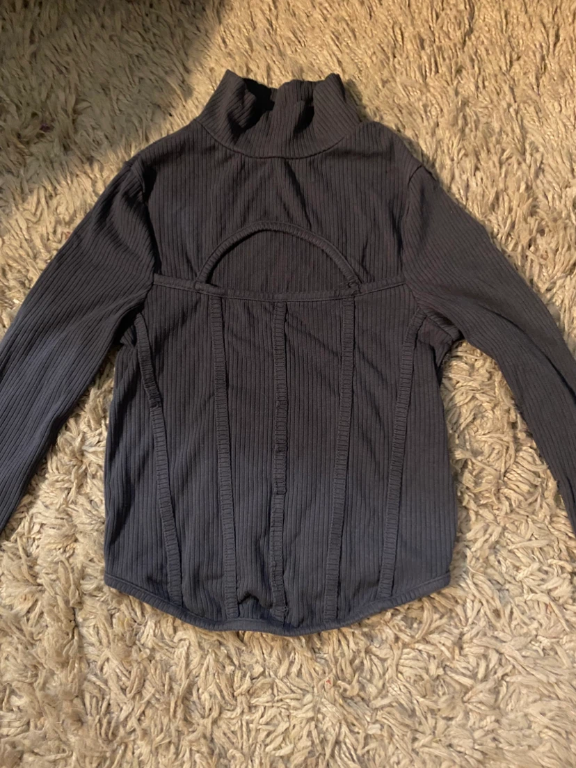 Grey turtleneck with bust window