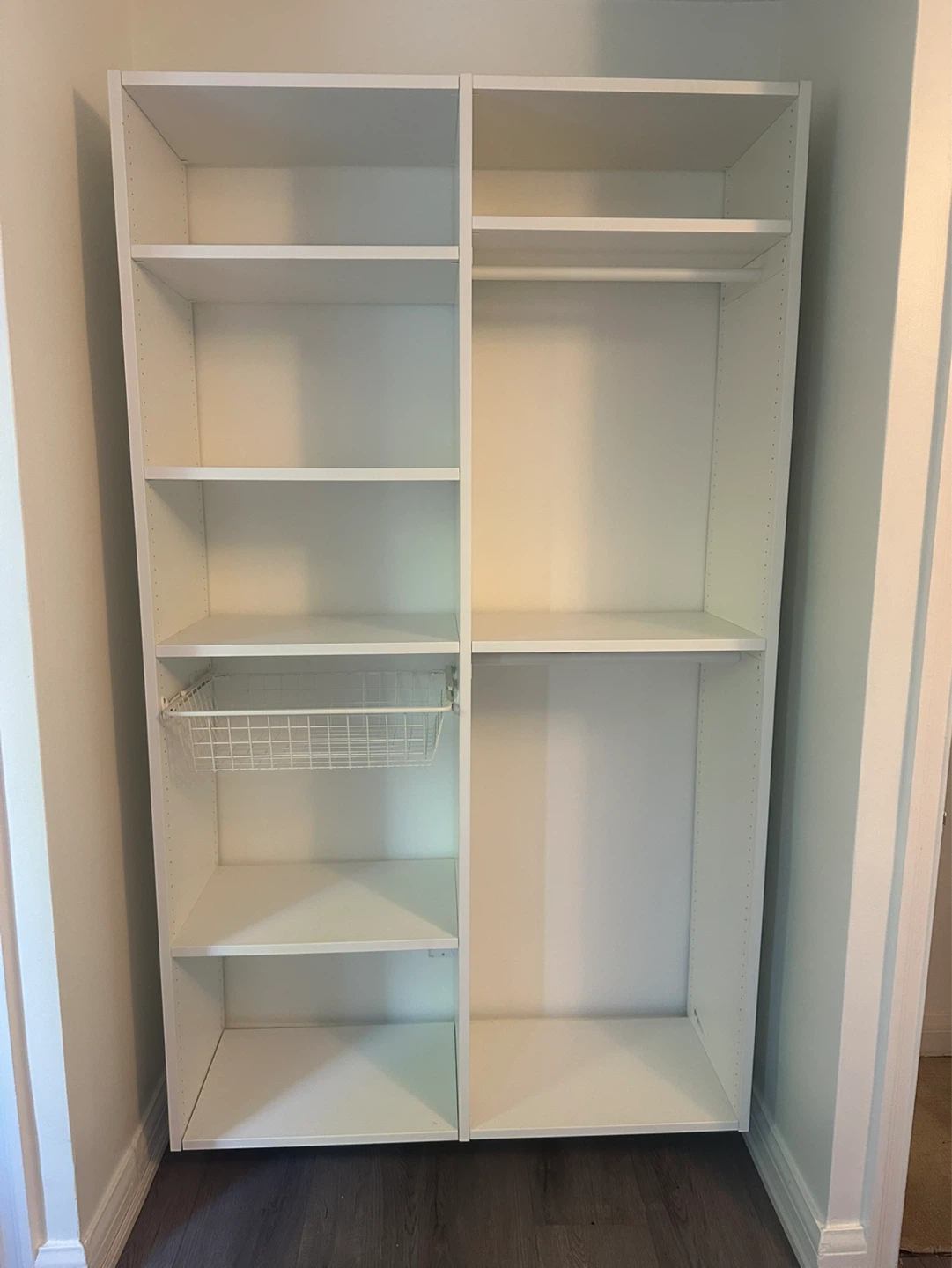 White Closet Storage Unit with Shelves and Hanging Rod