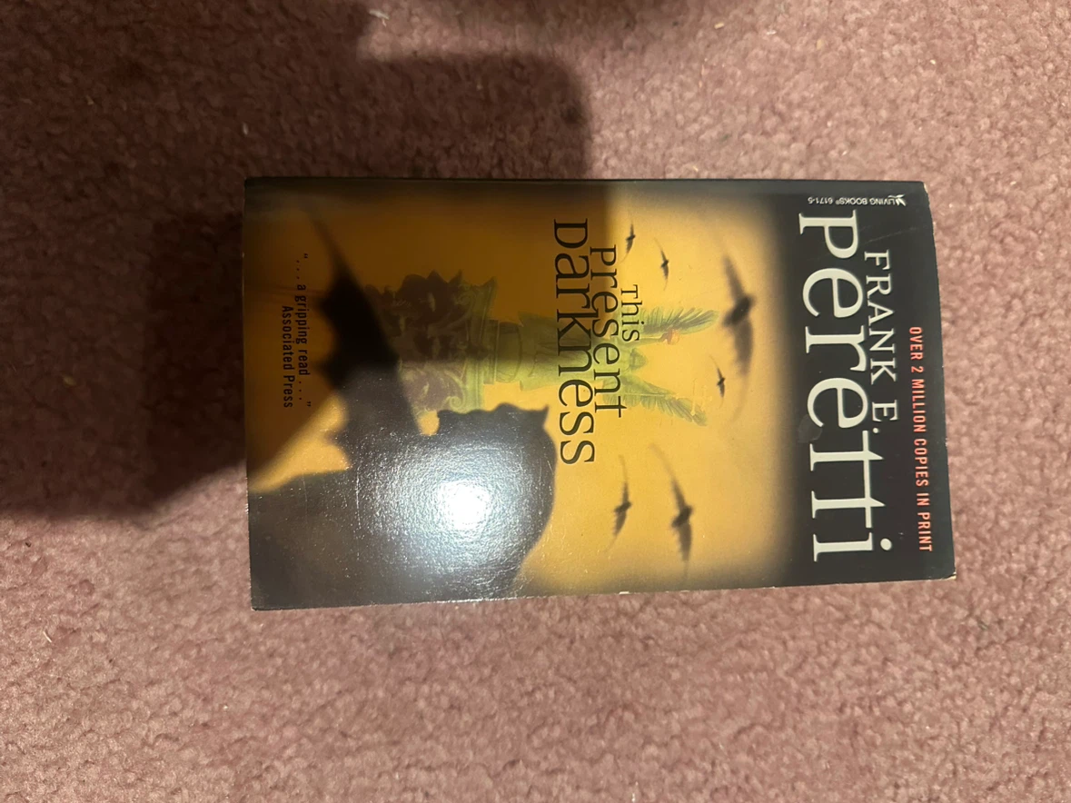This Present Darkness by Frank E. Peretti