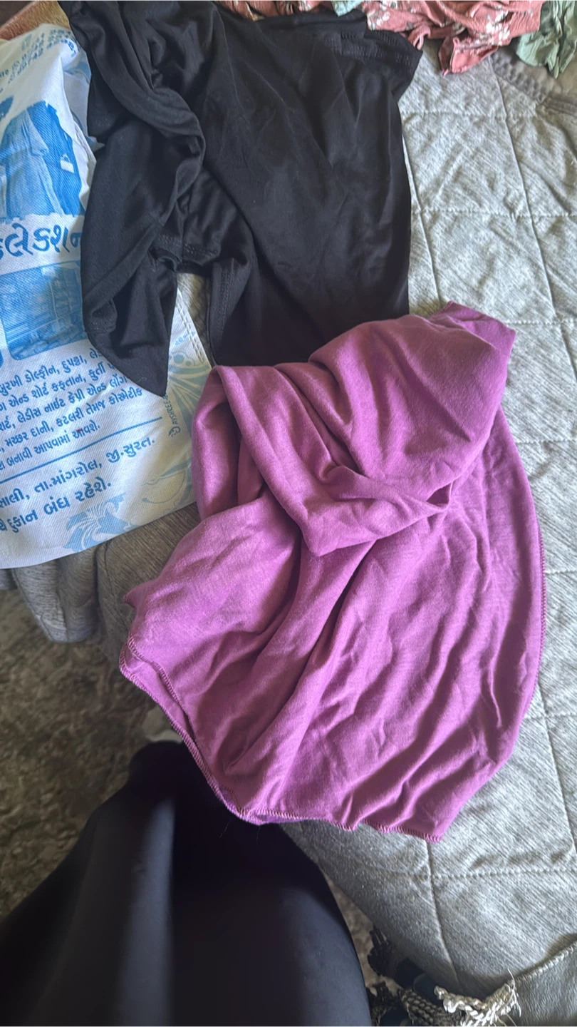 Two black kids hijab and 1 purple jersey like material scarf.