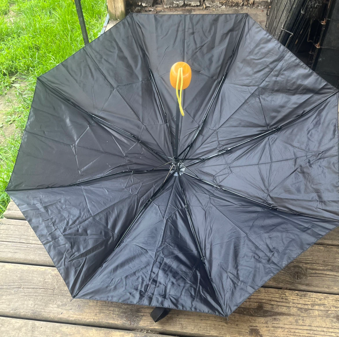 Black folding umbrella with wooden handle