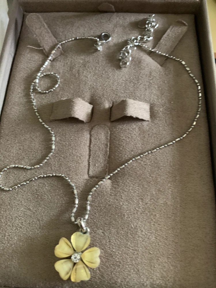 Silver-tone necklace with yellow flower pendant