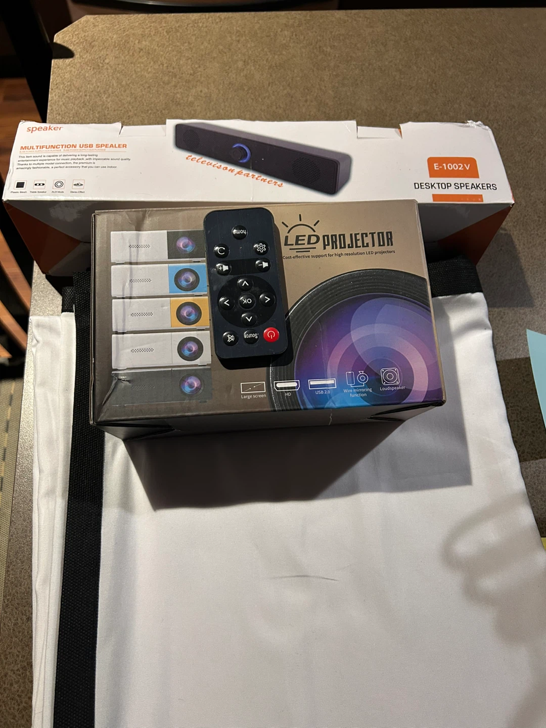 LED Projector, Desktop Sound Bar and 100” projector screen.