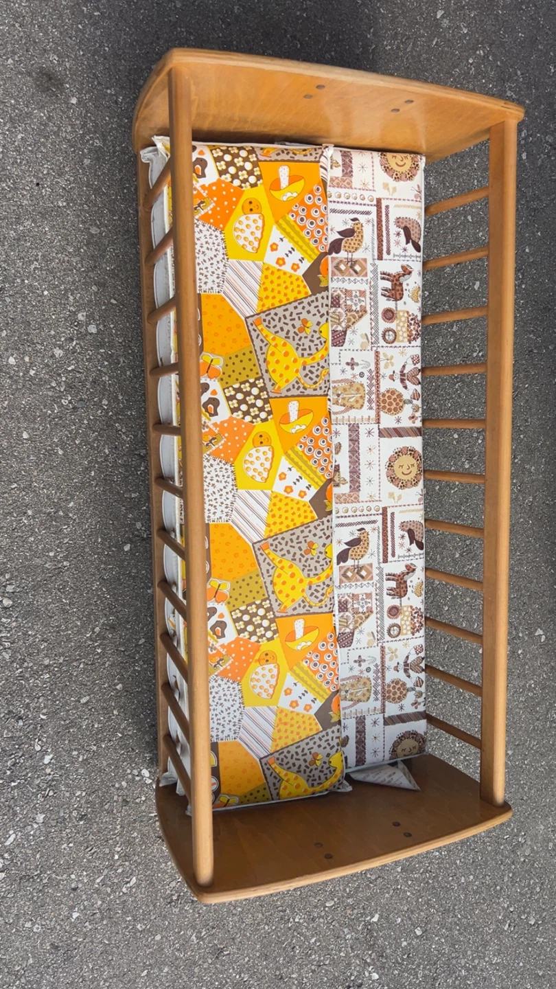 Wooden baby bassinet with patterned mattress