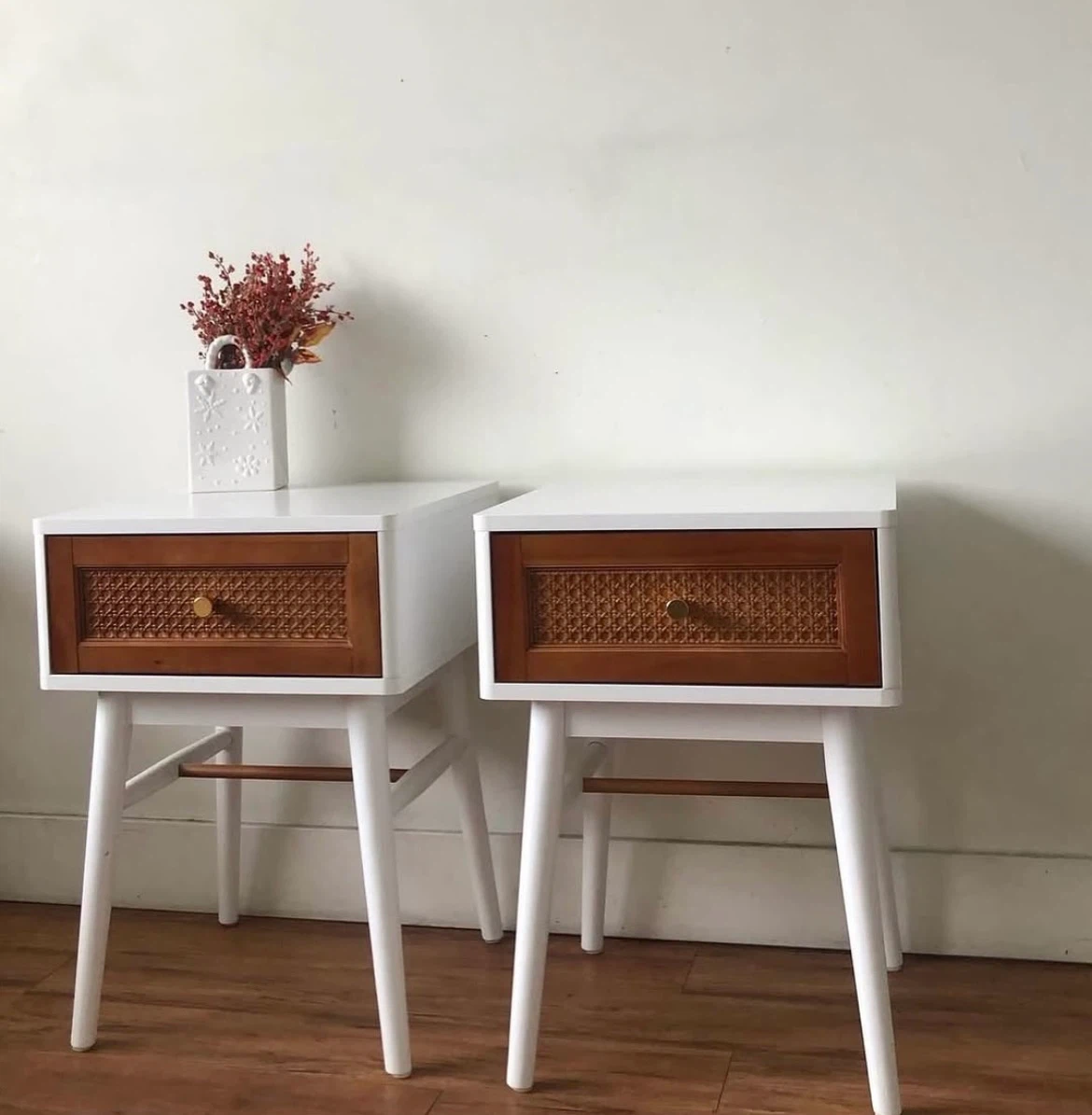 Pair of white nightstands with cane drawer fronts