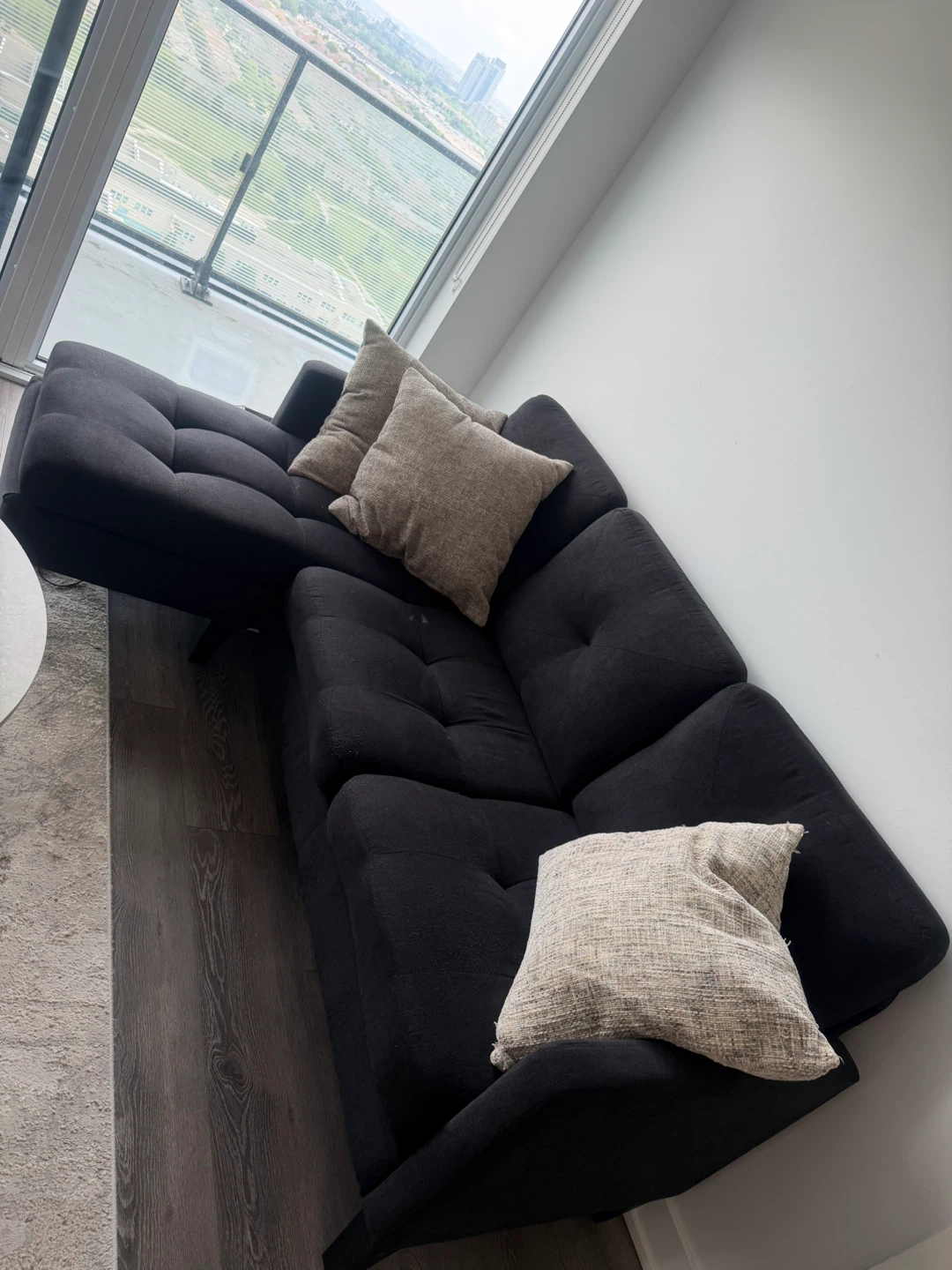 L-Shaped Black Sectional Sofa with Tufted Cushions