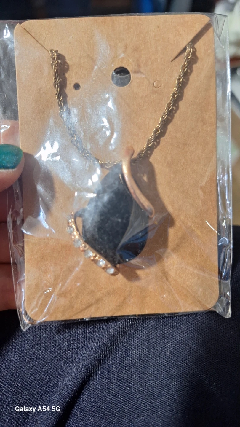 Gold-tone pendant necklace with black stone and crystals