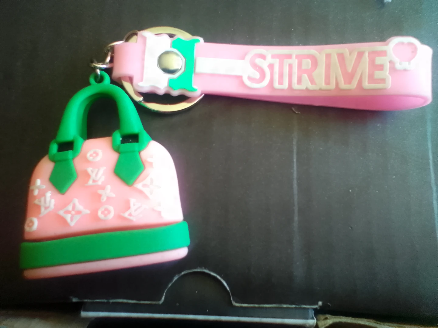 Pink handbag keychain with STRIVE strap