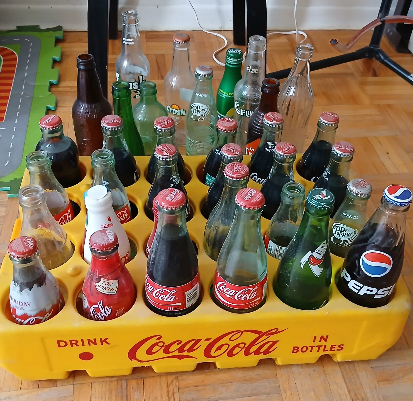 Collection of vintage soda bottles and crate