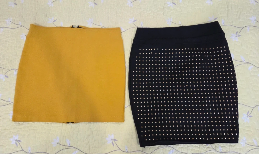Two skirts: mustard yellow with zipper, black with studs
