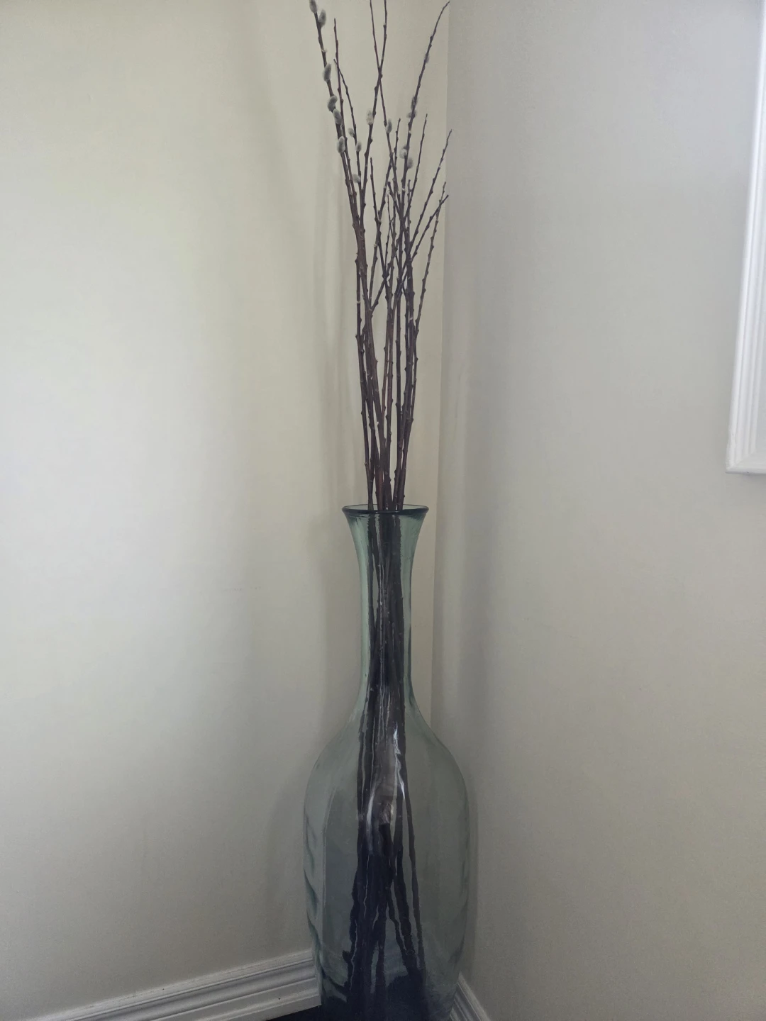 Large glass vase with decorative branches