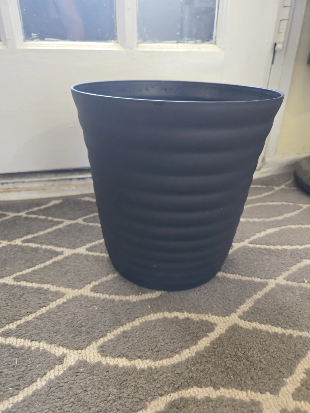 Black ribbed plastic planter pot