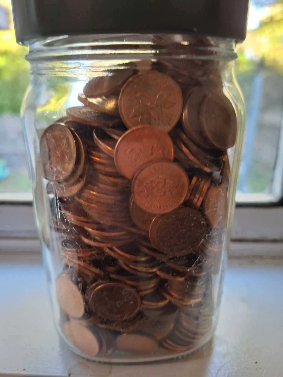 Glass pickle jar full of pennies - photo 2