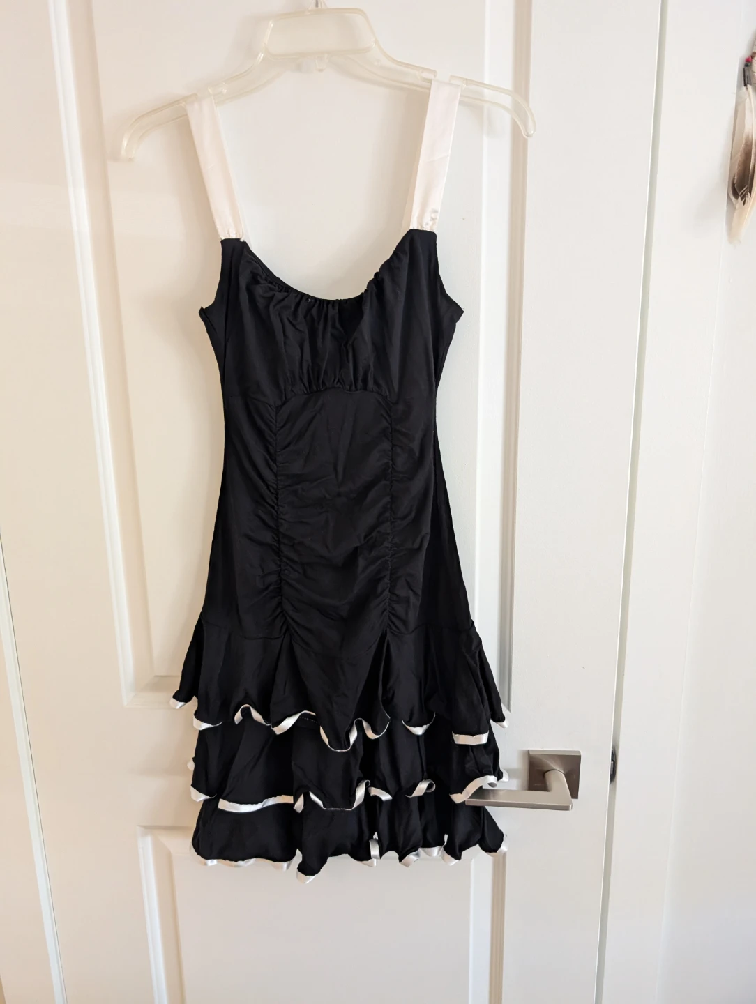 Black ruched mini dress with ruffled hem