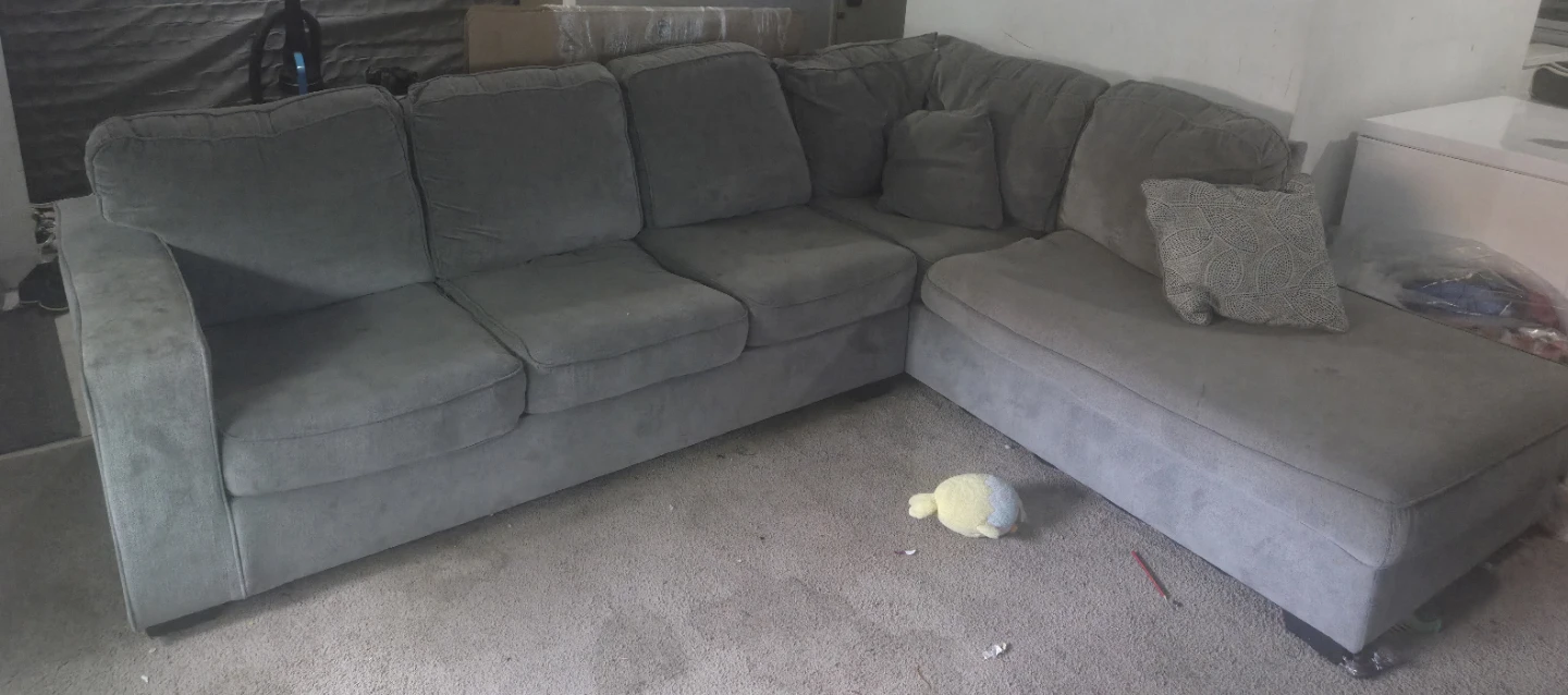 Grey Sectional Sofa and Two Black Chairs