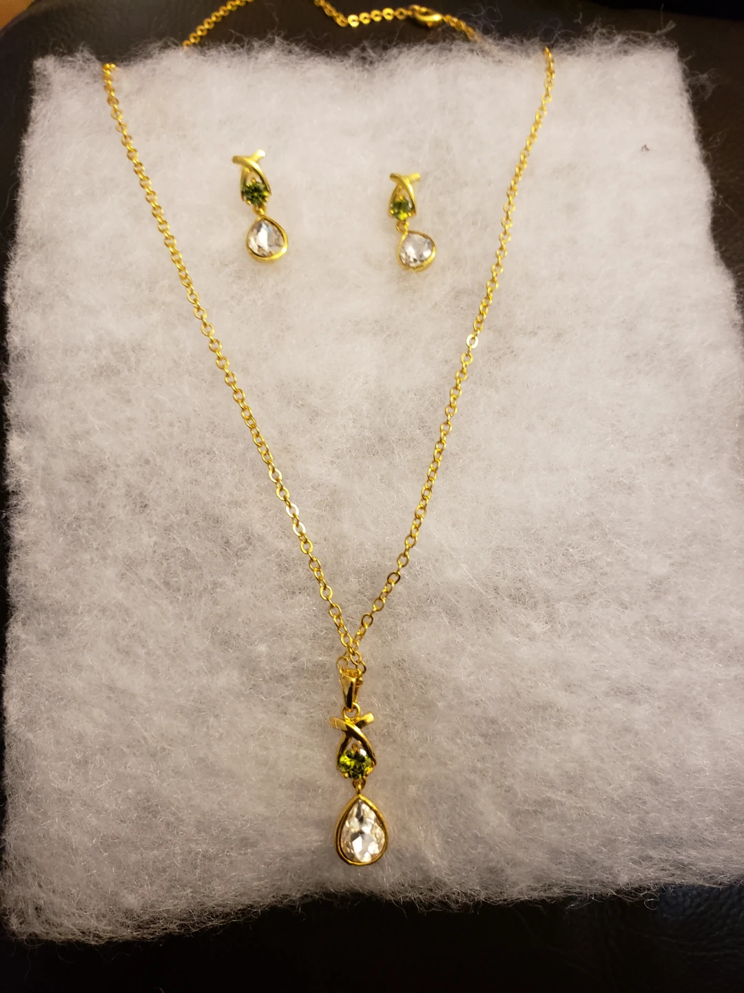 Gold-tone necklace and earring set with clear and green stones