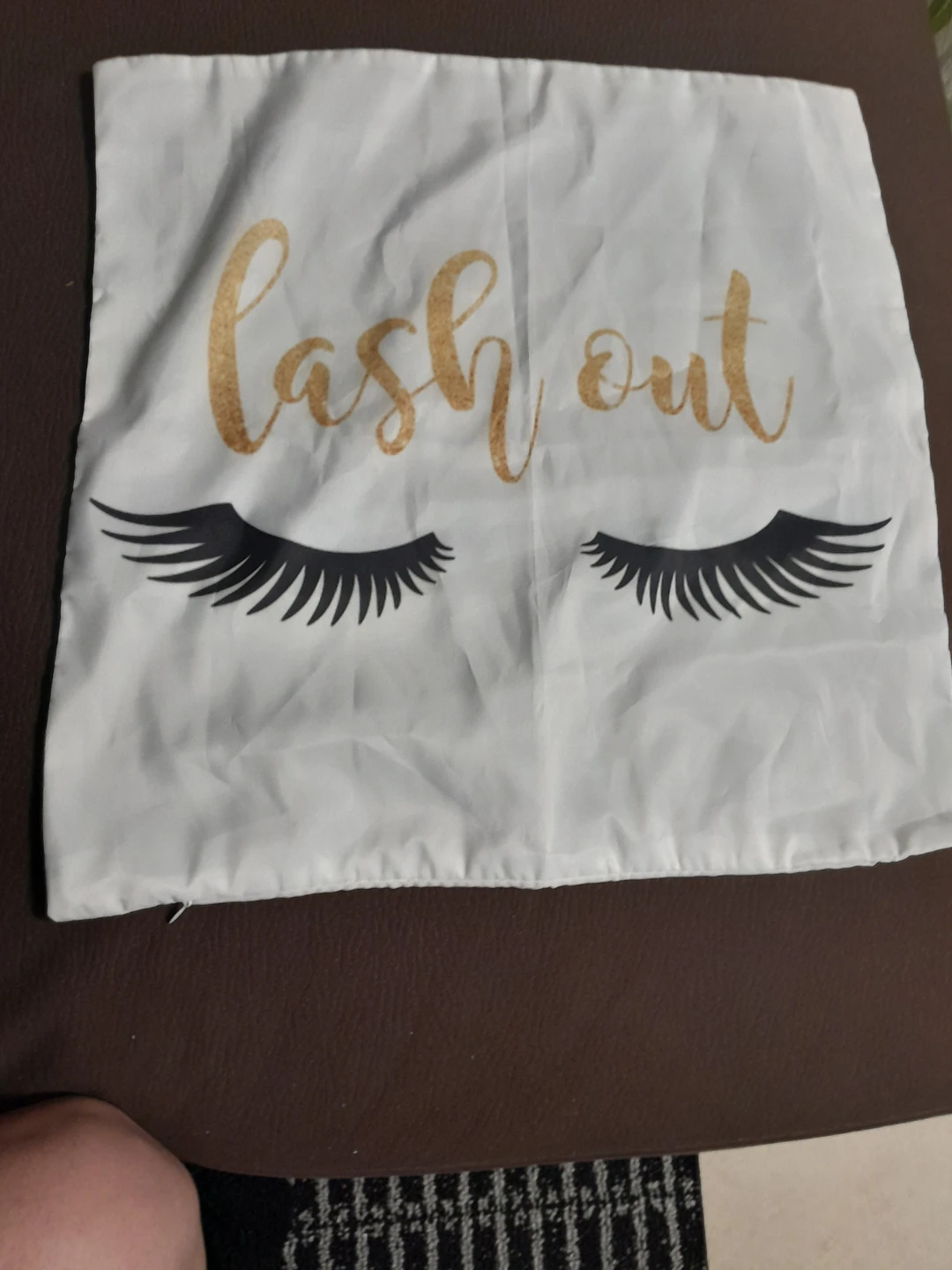 White Pillow Cover with Gold "Lash Out" Text