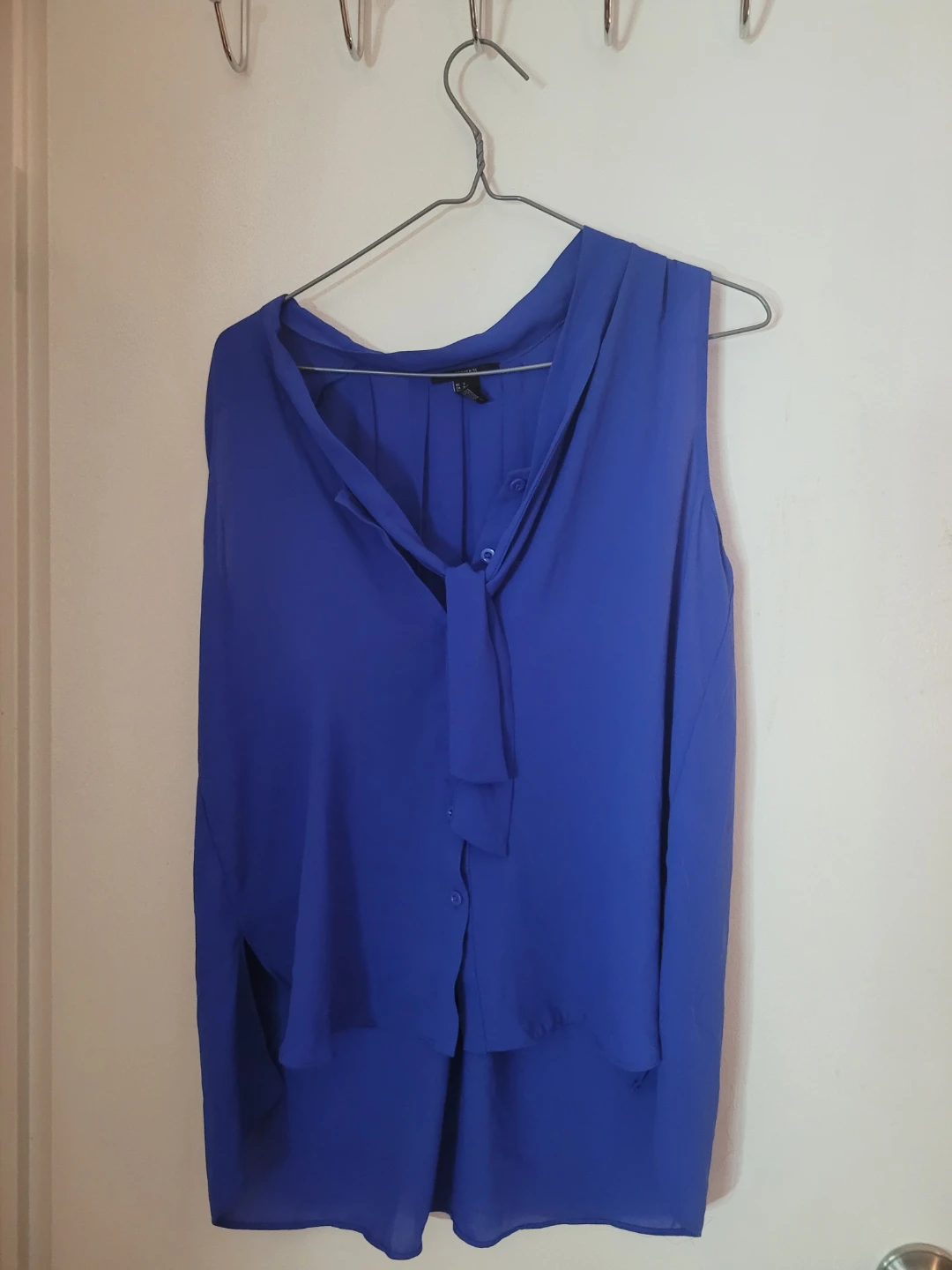 Blue Sleeveless Blouse with Bow Detail