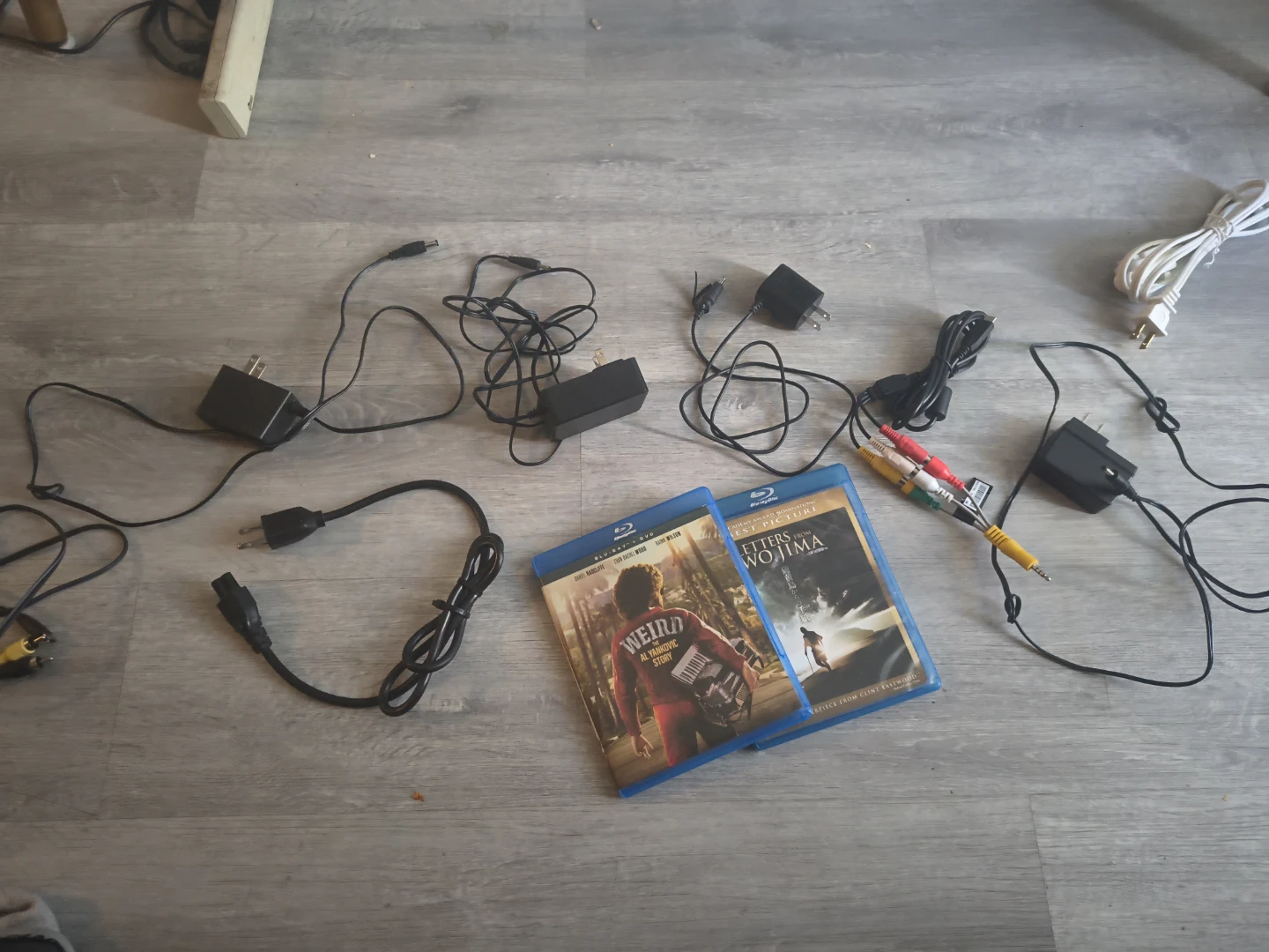 Assorted Power Adapters and Blu-ray Movies