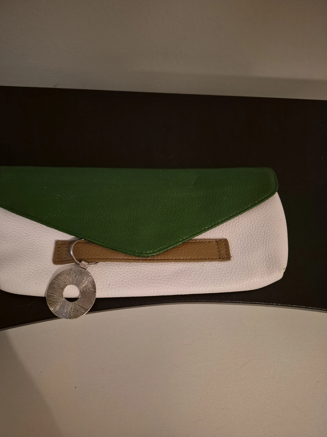White and green clutch with brown accent