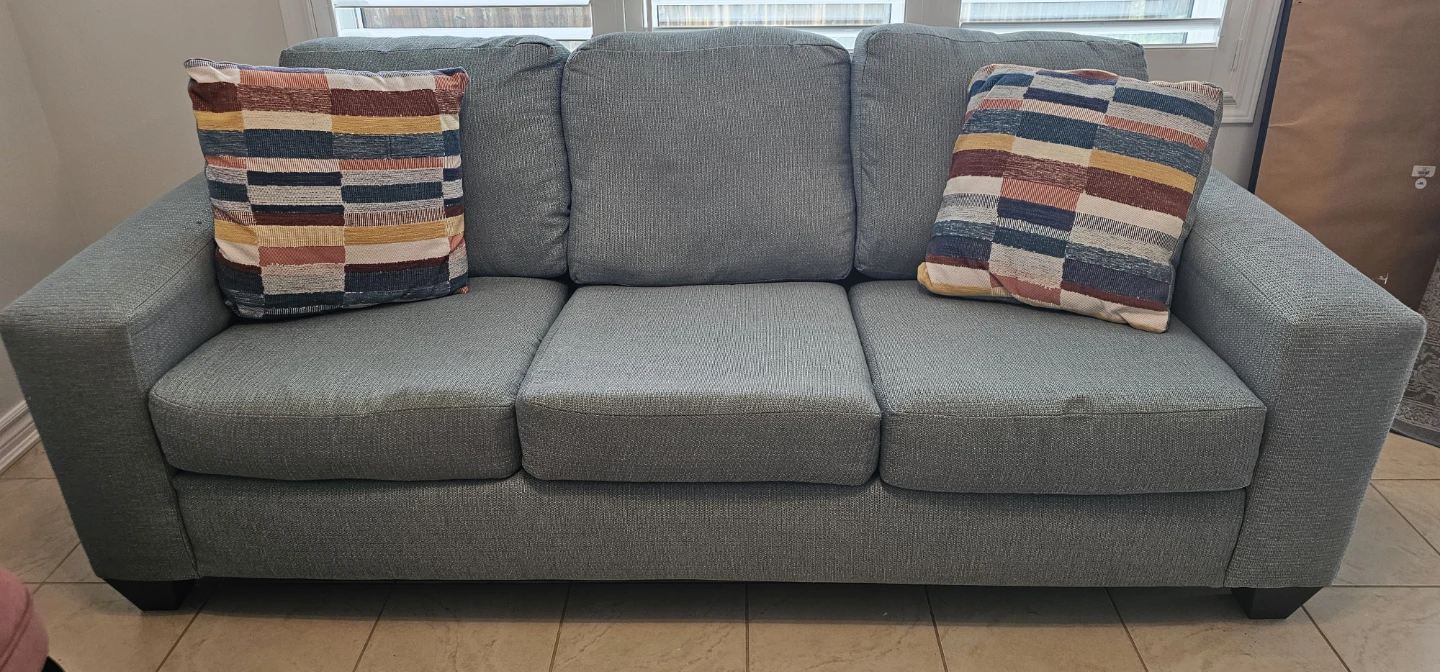 Light Green Three-Seater Sofa with Decorative Pillows