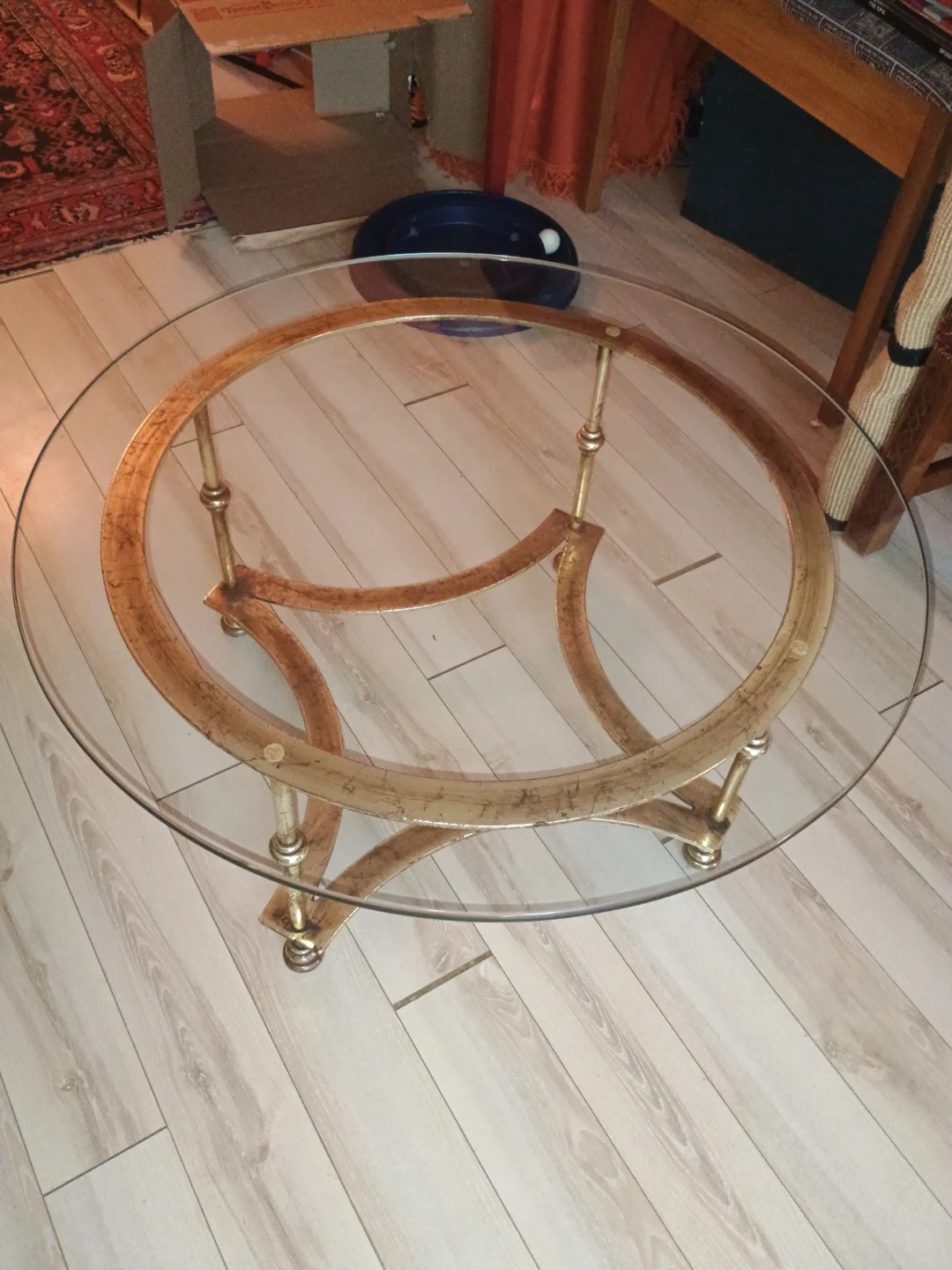 Round glass and gold-toned metal coffee table