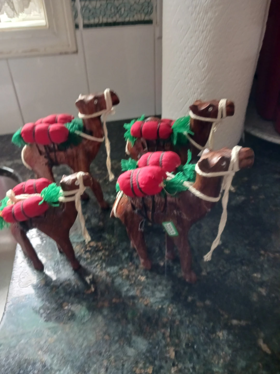 Set of 4 Decorative Wooden Camels with Red & Green Saddle Bags