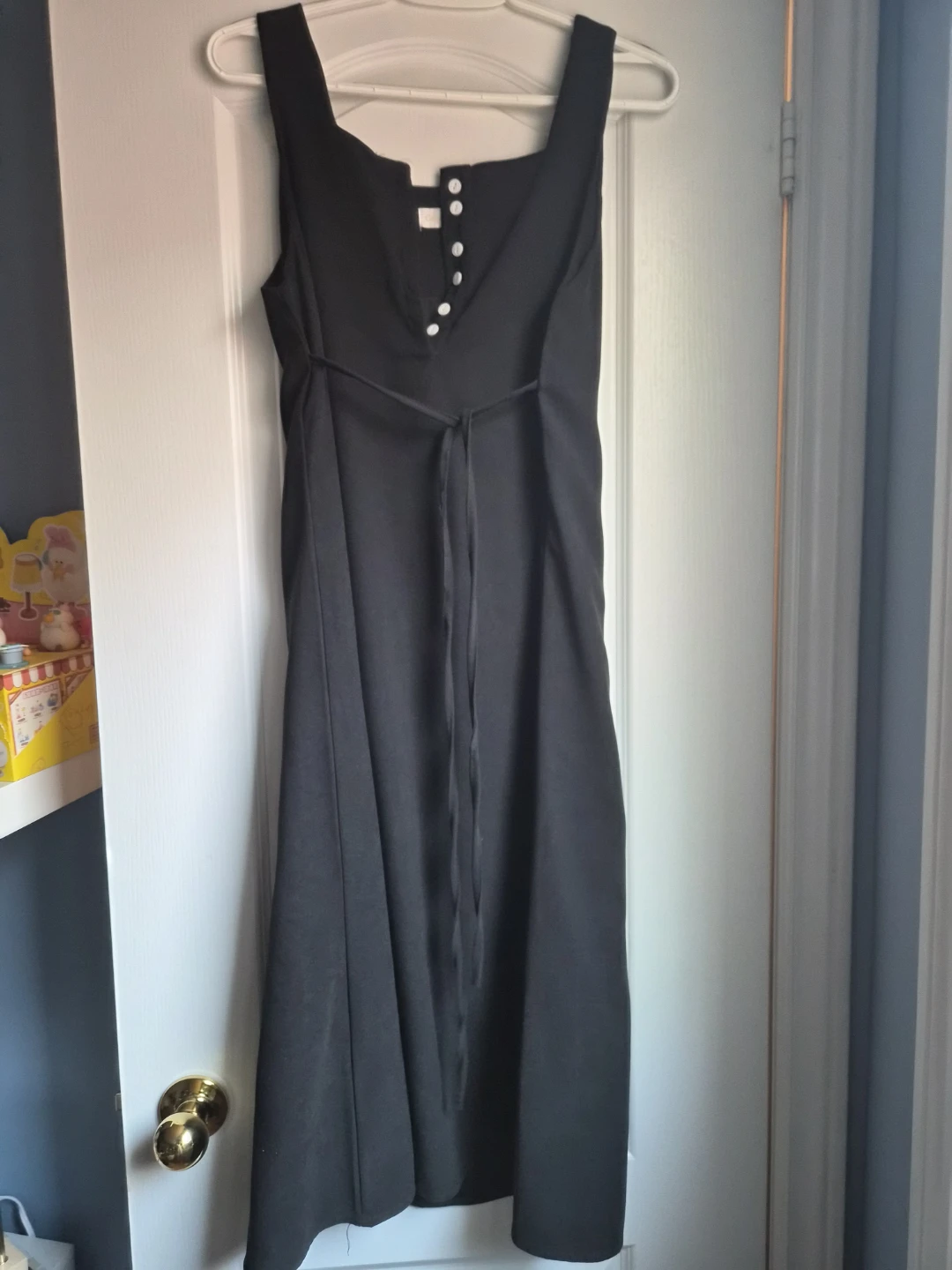 Black Sleeveless Dress with White Buttons