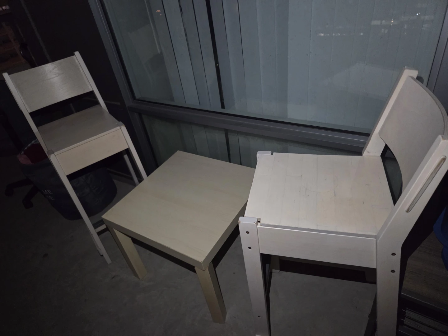 Two wooden chairs and a small table