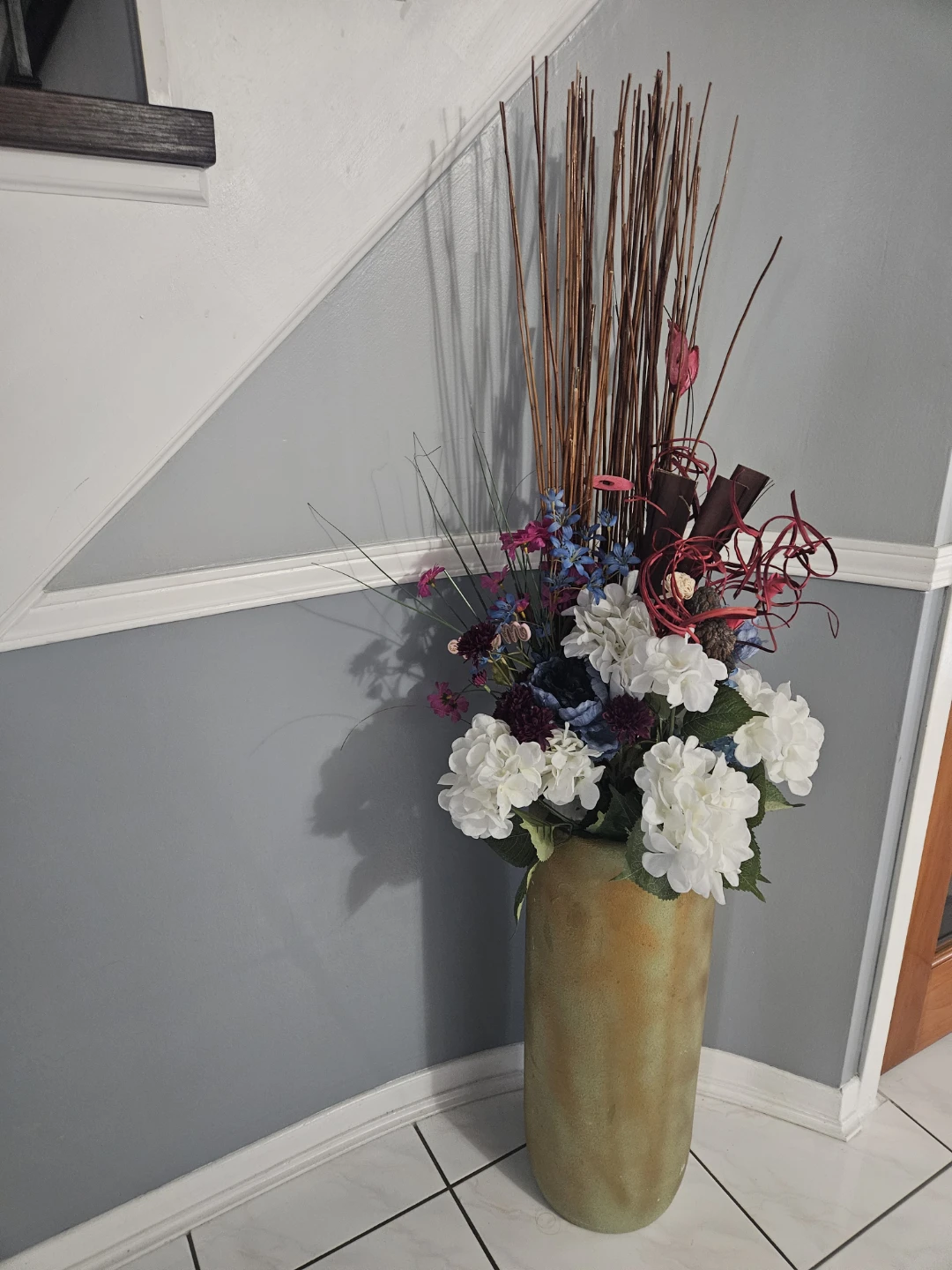Decorative floral arrangement in a tall vase