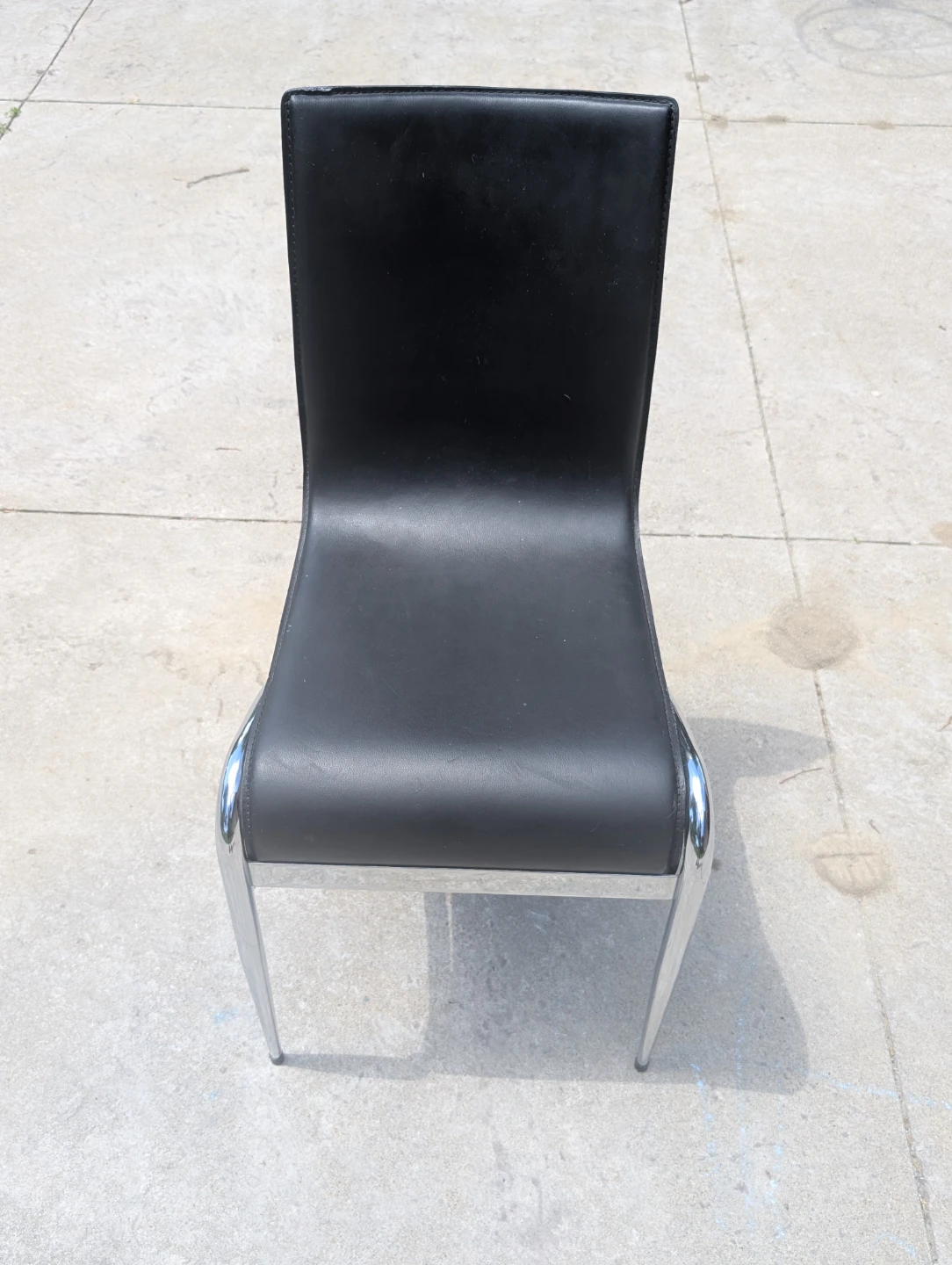 Black faux leather chair with chrome legs