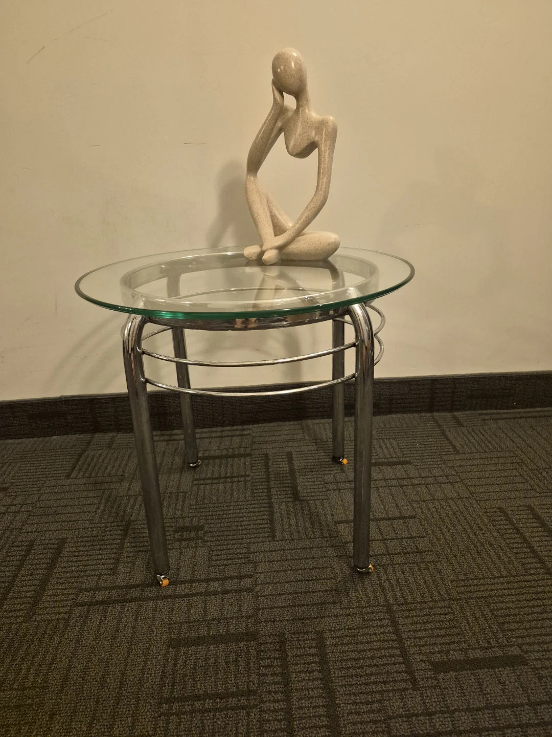 Glass top side table with silver legs and wheels - photo 2